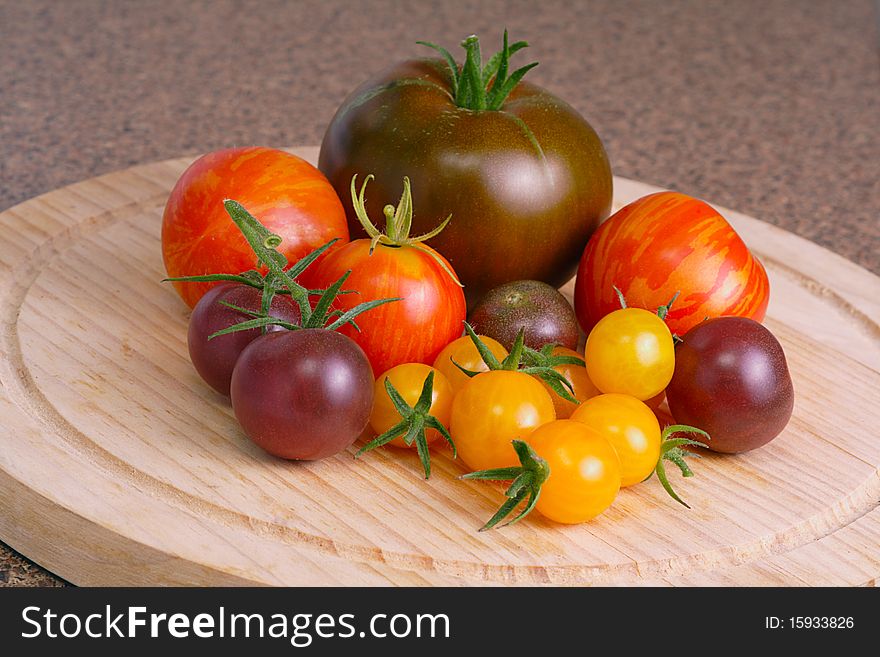 Collection of heritage tomatoes in vibrant colors of orange, brown, red and yellow. Collection of heritage tomatoes in vibrant colors of orange, brown, red and yellow