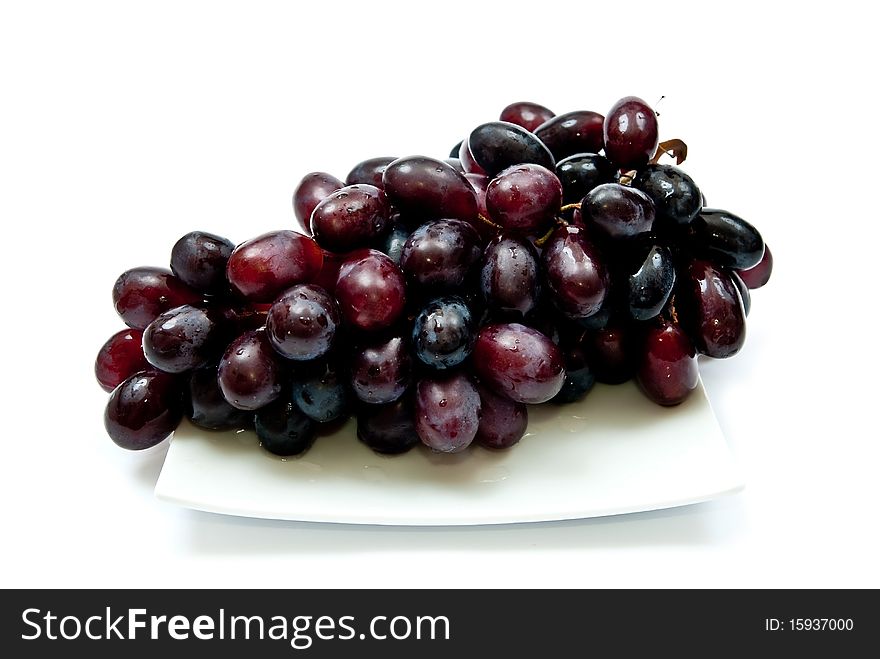 Bunch of grape on plate. Isolated on white background. Soft shadow
