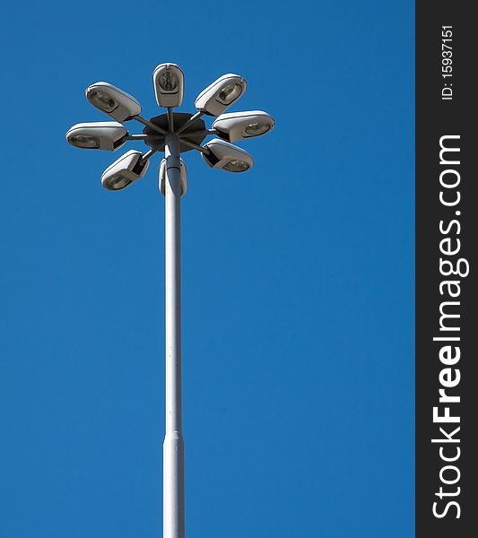 Detail of modern street light on blue sky.