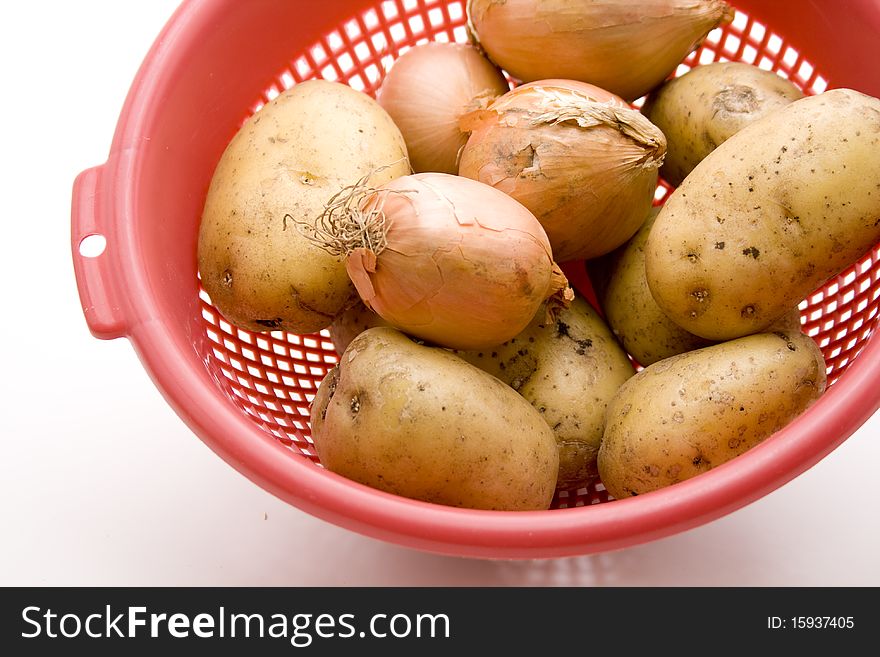Raw potatoes in the kitchen sieve with onions. Raw potatoes in the kitchen sieve with onions