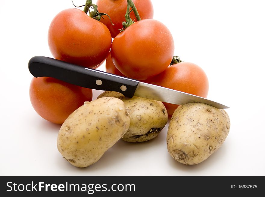 Tomatoes and potatoes with knife