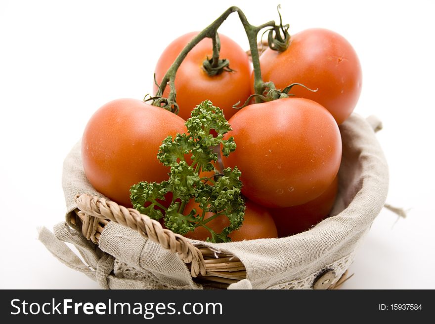 Tomatoes with parsley in the basket. Tomatoes with parsley in the basket