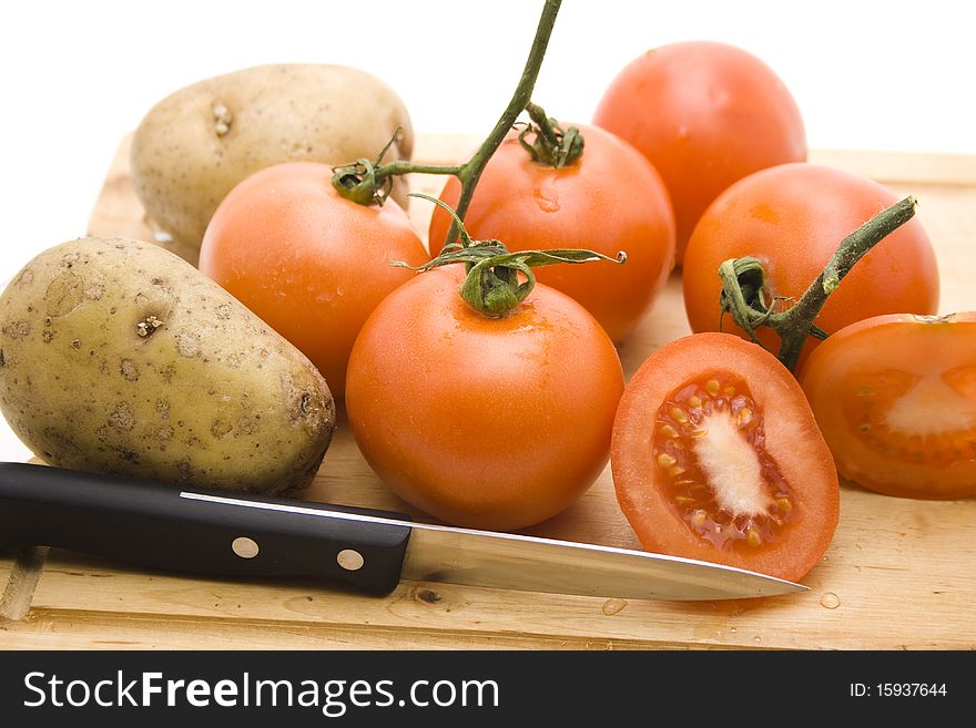 Tomatoes and potatoes with knife. Tomatoes and potatoes with knife