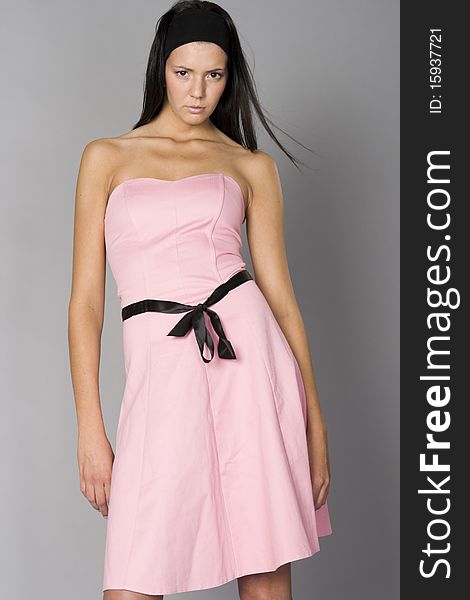 Beautiful slim woman in pink dress