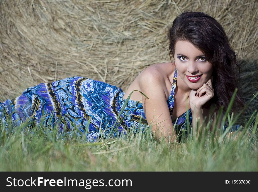 Young beautiful girl near haystacks