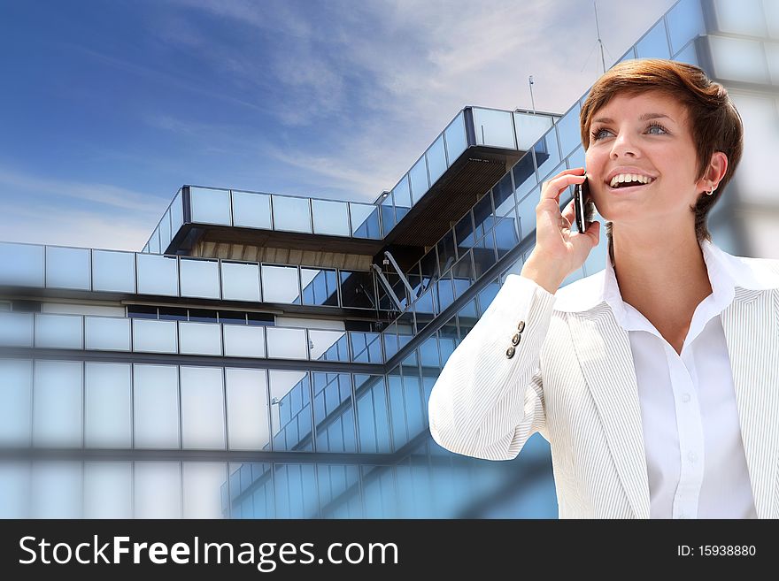 Businesswoman on the phone in front of building. Businesswoman on the phone in front of building