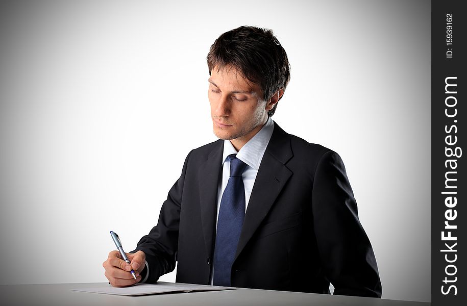 Portrait of a businessman signing a document. Portrait of a businessman signing a document