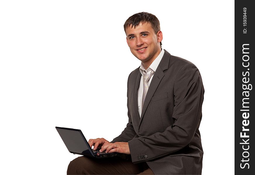 Happy young businessman using laptop. Happy young businessman using laptop