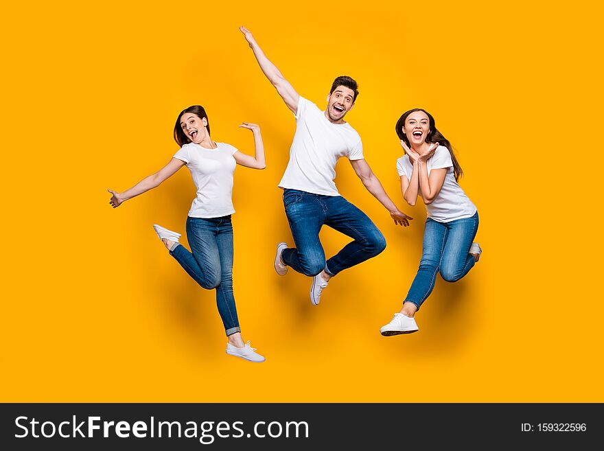 Full length body size view portrait of three nice attractive slim cheerful cheery comic foolish carefree careless person buddy fellow, having fun isolated over bright vivid shine yellow background