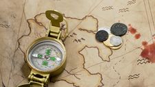 Compass And Coins On A Map Royalty Free Stock Images Compass And Coins On A Map Royalty Free Stock Images