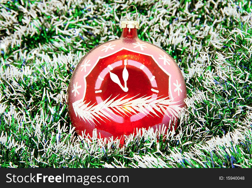 Red fur-tree sphere with hours per a tinsel. Red fur-tree sphere with hours per a tinsel