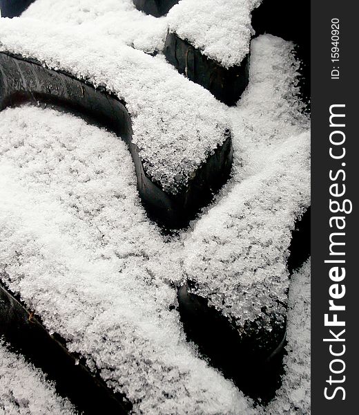 Tractor tires are covered with snow