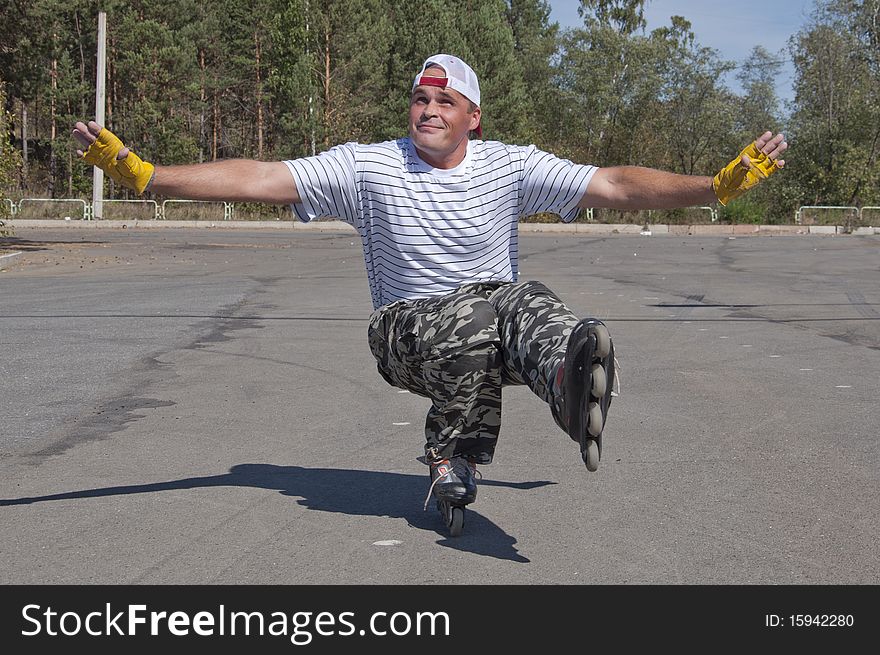 The man goes for a drive on roller skates in a sun