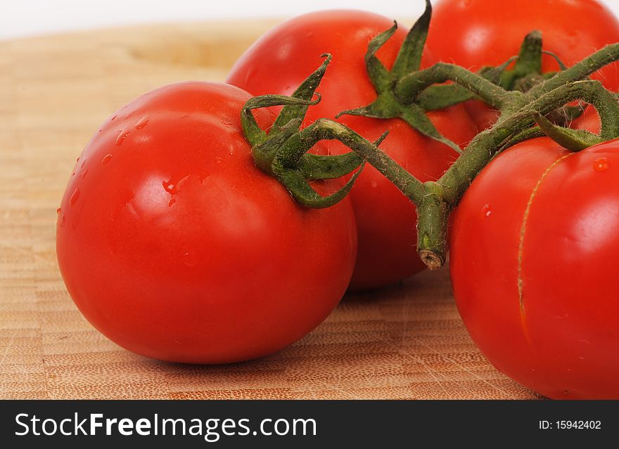 A close-up of fresh tomatos and their leaves