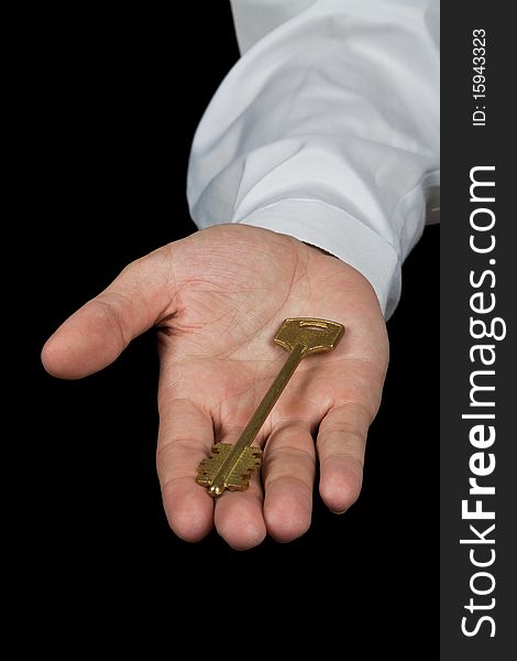 Businessman holding key of success isolated on the black background