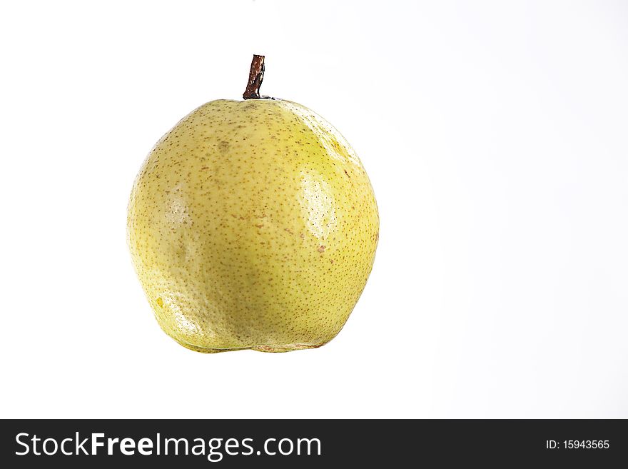 A sweet ripe juicy pear fruit isolated against a white background. A sweet ripe juicy pear fruit isolated against a white background