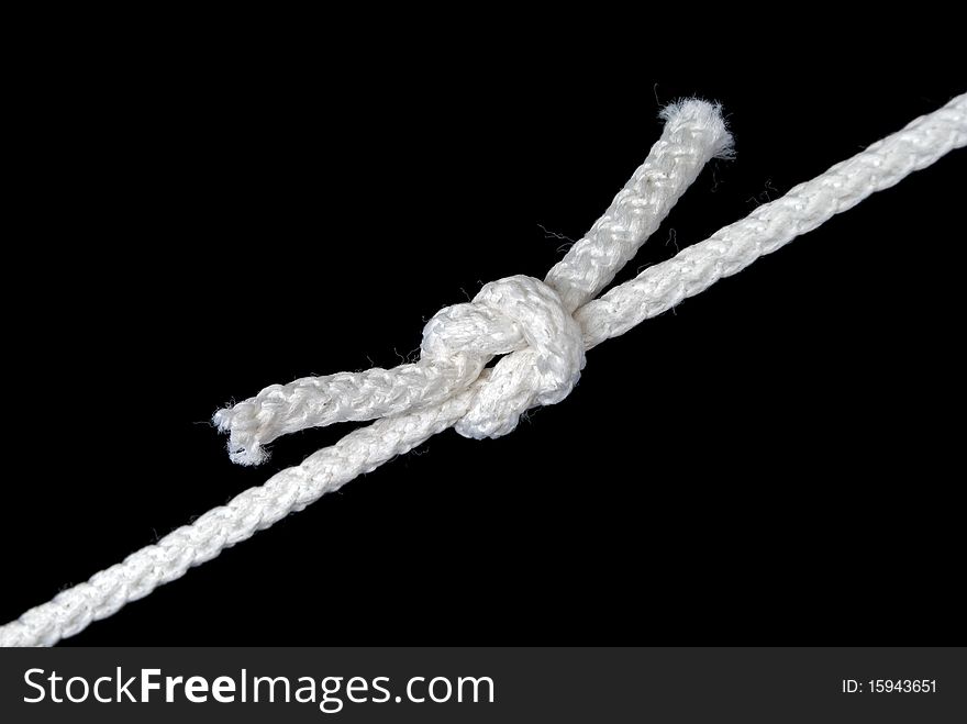Knot close up isolated on black