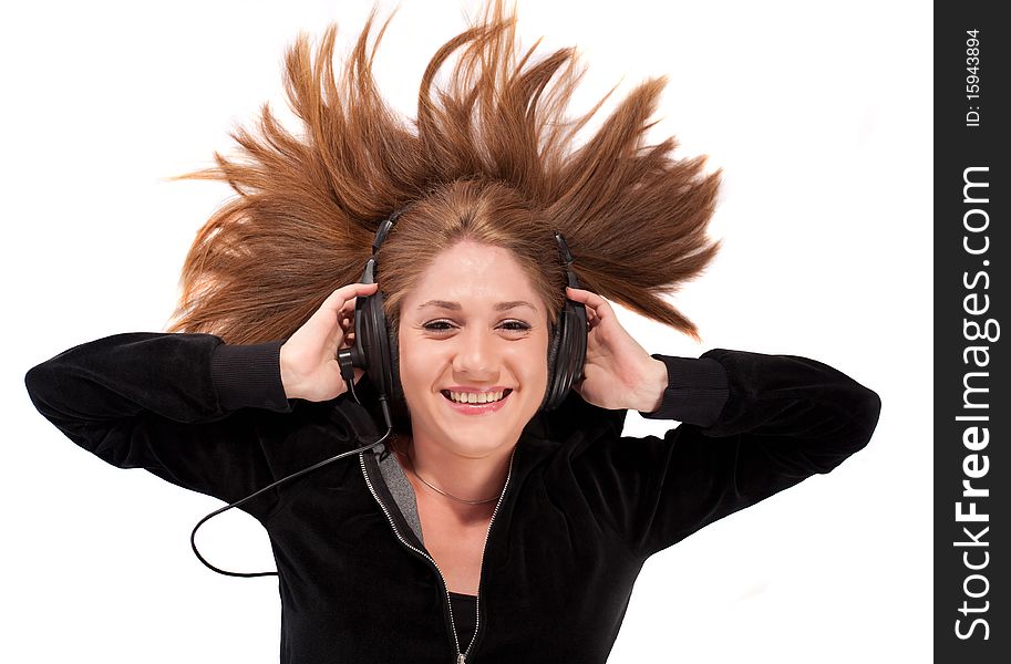 Young woman laid on her back enjoying music,isolated on white