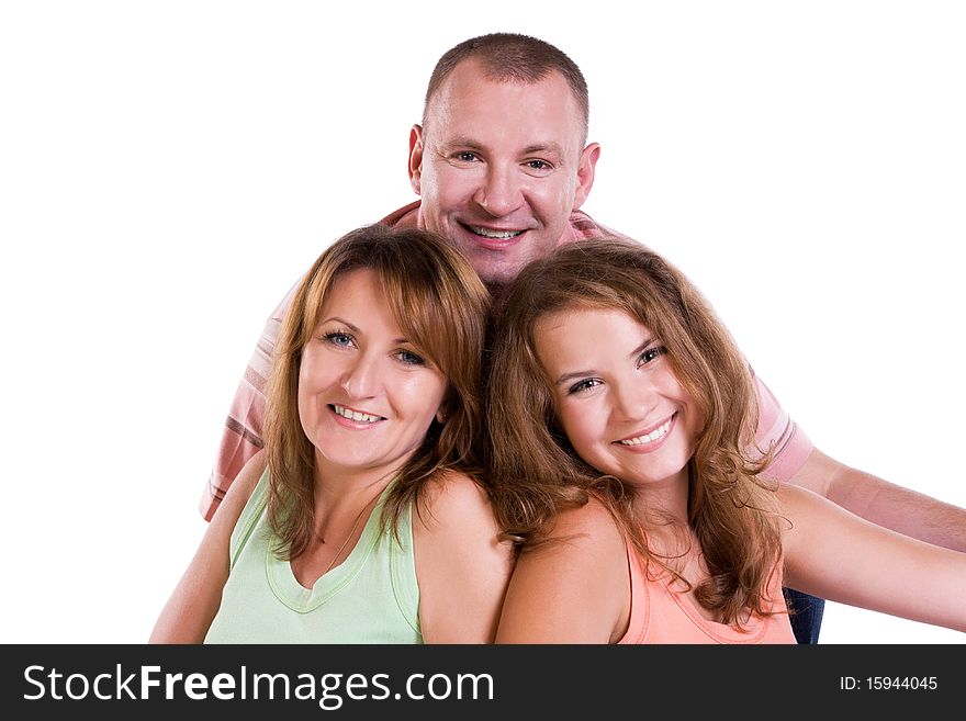 Happy family. Mother, father and daughter are smiling . Woman, man and girl are lying on the floor and posing happily on white background.