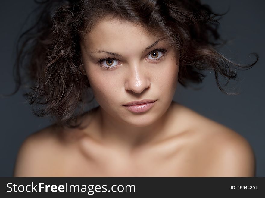 Studio portrait of attractive young woman on blue background