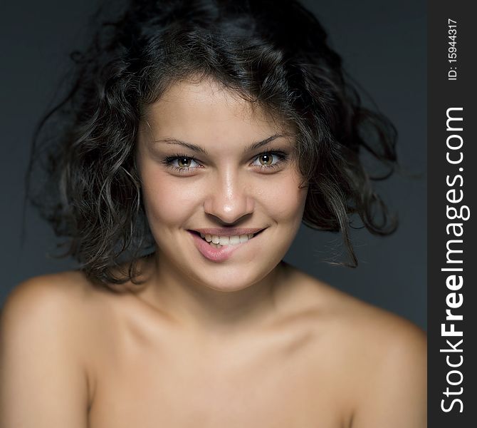 Studio portrait of attractive young woman on blue background