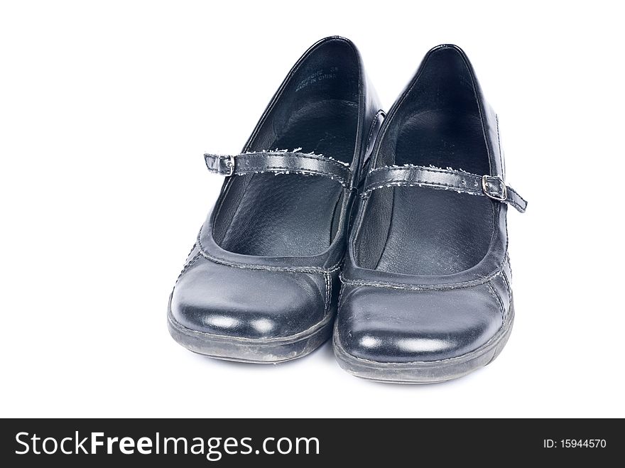 A pair of woman's black leather shoes isolated on white. A pair of woman's black leather shoes isolated on white.