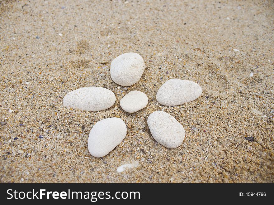 White spa stones on the beach in summer day