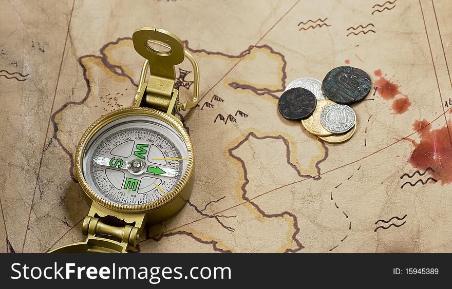 Compass and coins on a map