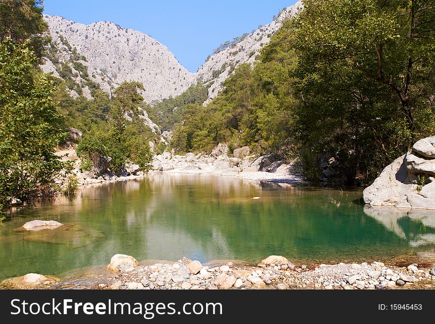 Pond in the canyon of green mountains. Pond in the canyon of green mountains