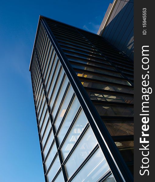 Office building. Blue sky in the background. Glass windows