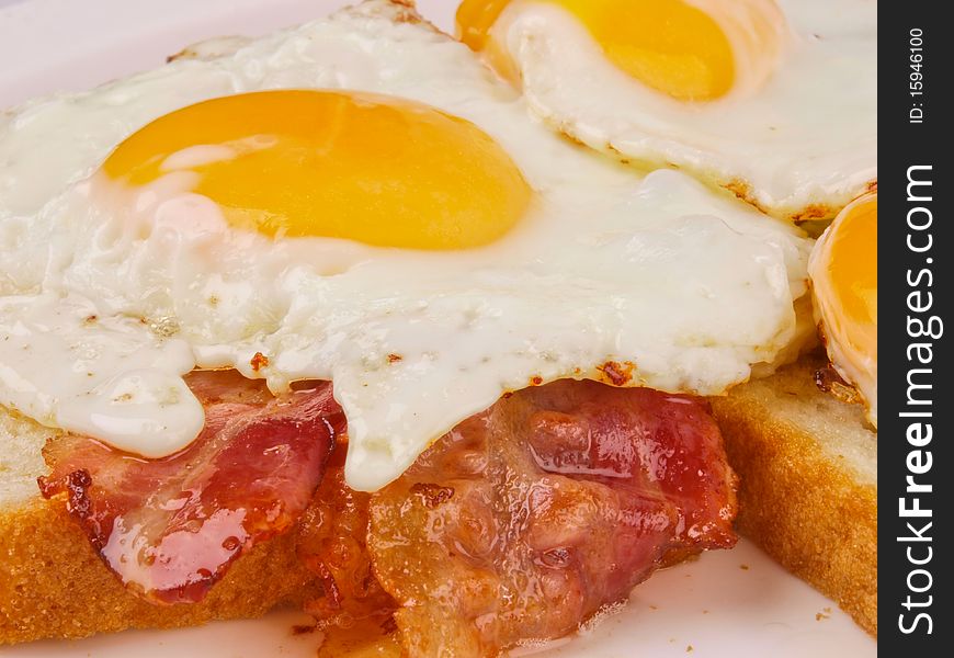 Egg and bacon. Close up on a slice of bread