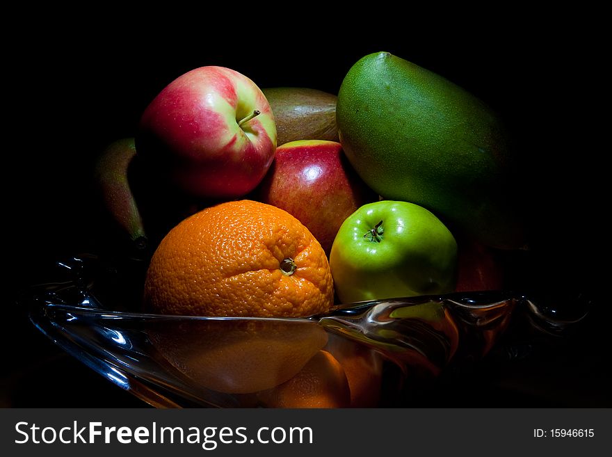 Fruit bowl with apples, oranges, kiwi, pears, mango