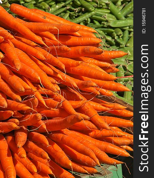 Fresh carrots on a market pees in the background