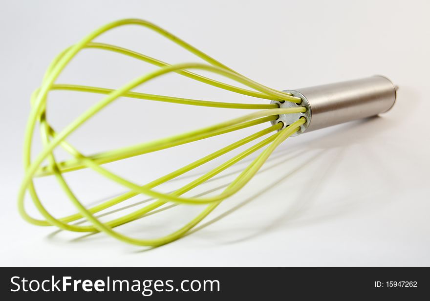 Green whisk for cooking.Close up