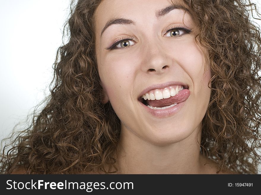 Playful beautiful young woman sticking her tongue out