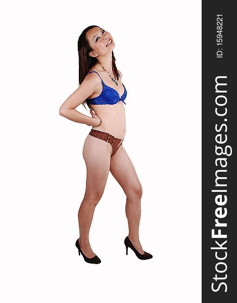 A slim young Chinese woman in blue and brown underwear standing in the studio on high heels and having fun, on white background. A slim young Chinese woman in blue and brown underwear standing in the studio on high heels and having fun, on white background.