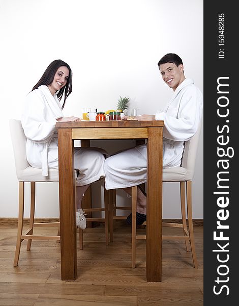 Sexy young smiling couple is having morning together in the appartment, eating healthy breakfast. Sexy young smiling couple is having morning together in the appartment, eating healthy breakfast