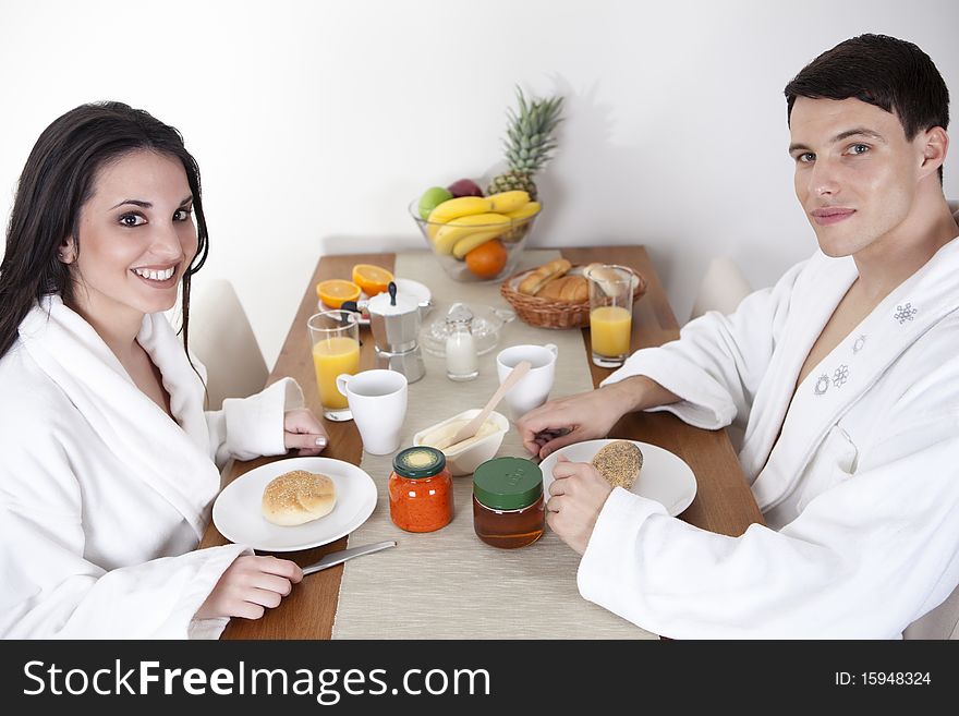 Sexy young couple in the morning having breakfast