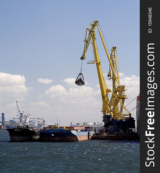 Crane unloading a cargo ship in Constanta harbour, at the Black Sea