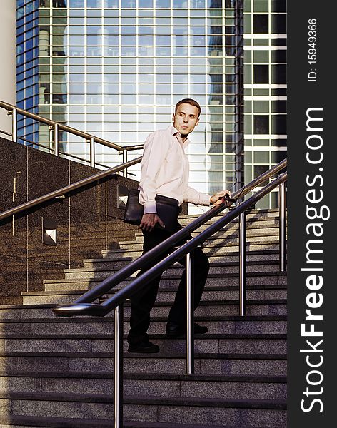 A man with a briefcase walking to work in the business center