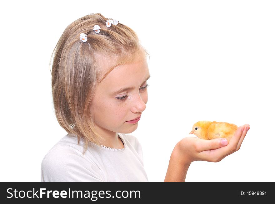 A happy little girl holding a baby chicken.