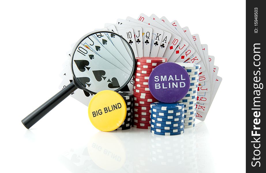 Gambling chips and cards with a magnifying glass for casino games isolated over white