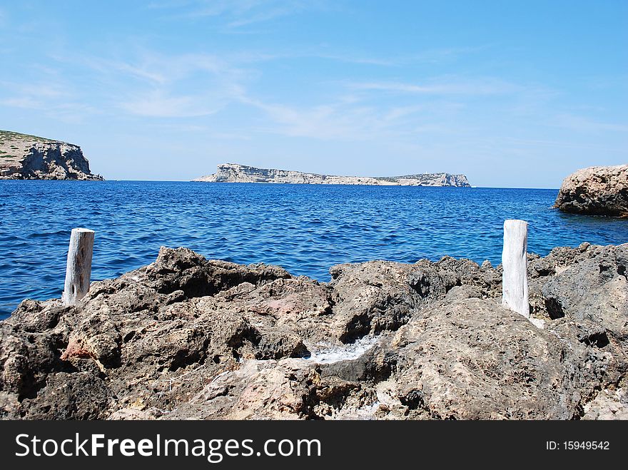 On the horizon, the island of Sa Conillera, near the island of Ibiza. Part of a nature reserve. On the horizon, the island of Sa Conillera, near the island of Ibiza. Part of a nature reserve.