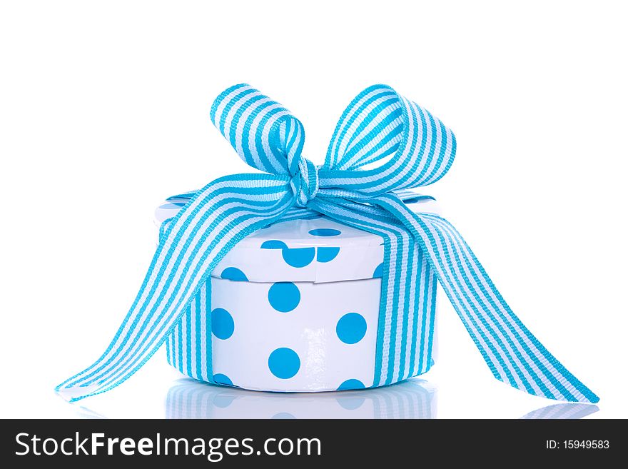 A blue white dotted giftbox with a striped ribbon isolated over white