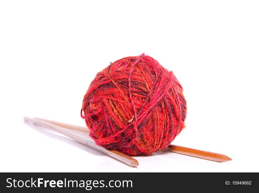 Knitting needles and red wool isolated on white