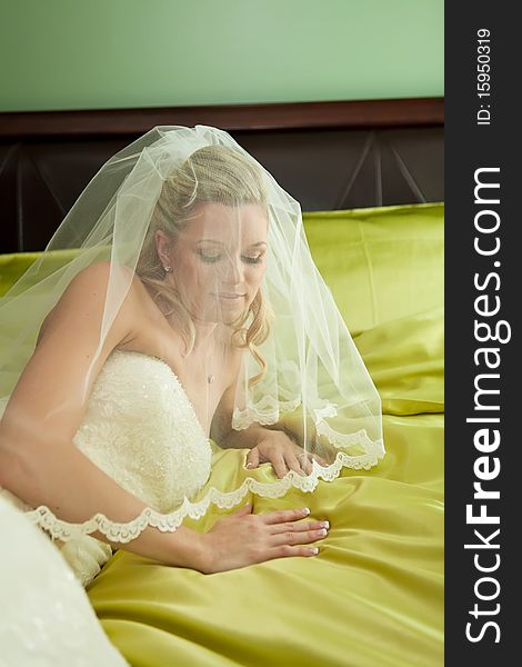 Beautiful bride lying on her bed