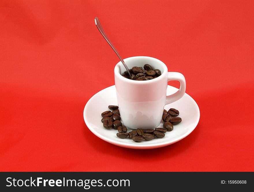 A cup of coffee with beans. A cup of coffee with beans
