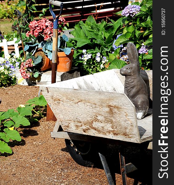 Flower and vegetable garden with surrounding tools.