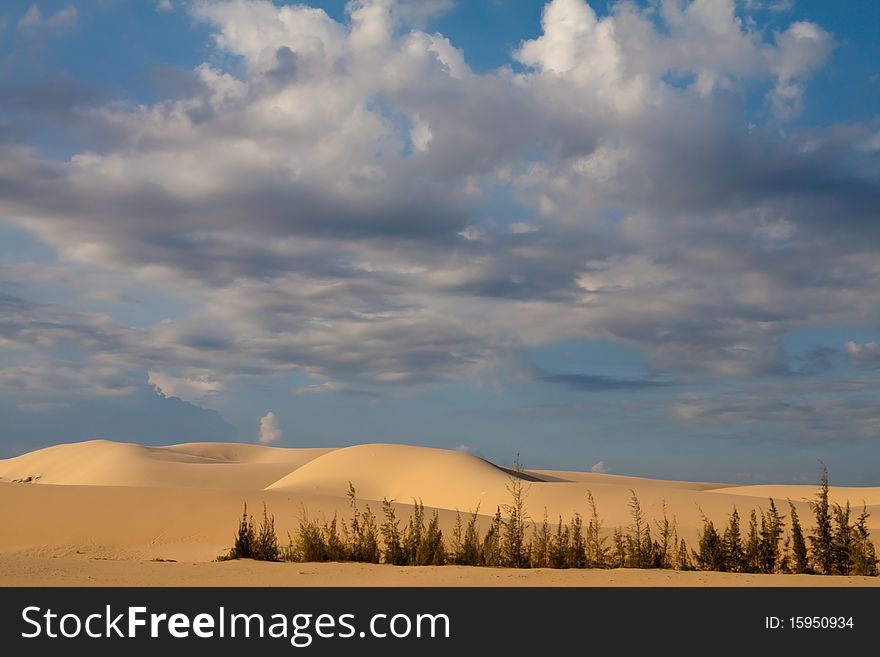 Sand dunes with a cloudy sky in Mui Ne, central Vietnam