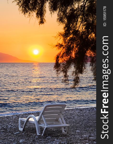 Chair on beach at sunset - nature vacations background